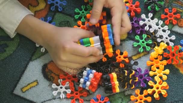 Little child plays in kindergarten indoors — Stock Video