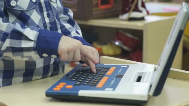 Boys hands play with toy laptop — Stock Video