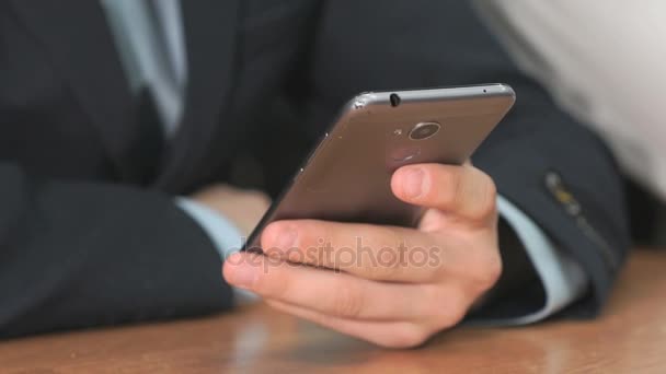 Unknown student holding grey smartphone — Stock Video