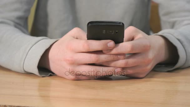 Unknown student holding black smartphone — Stock Video