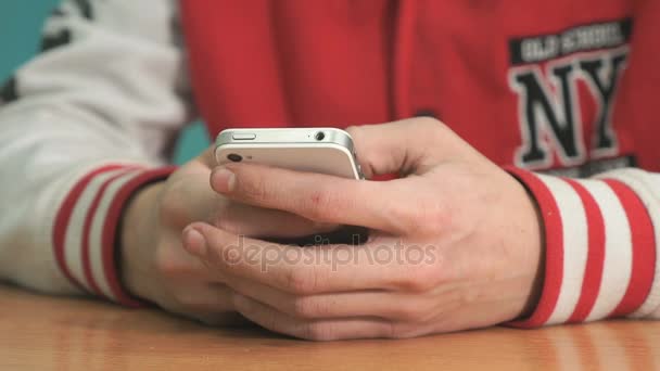 Unknown student holding silver-white smartphone — Stock Video