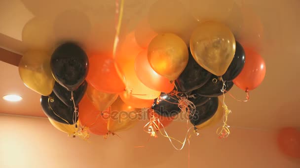 Bunte Luftballons schweben drinnen an der Decke — Stockvideo