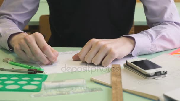 Close-up of unknown schoolboy removing text — Stock Video