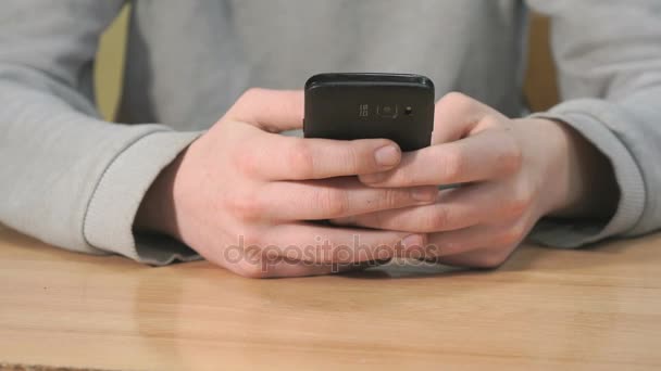 Unknown student holding black smartphone — Stock Video