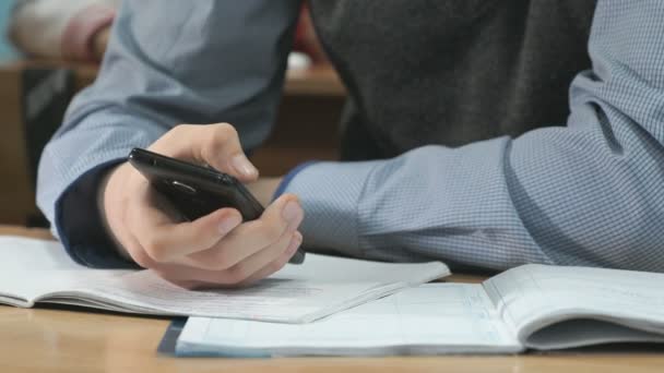 Unknown student holding black smartphone — Stock Video