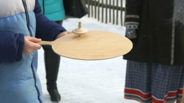 Unknown boy rotates wooden spinner. Close-up — Stock Video