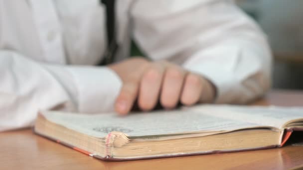 Unknown man reading a book. Close-up — Stock Video