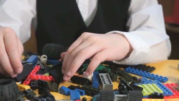 Hands of unknown child playing with building kit — Stock Video