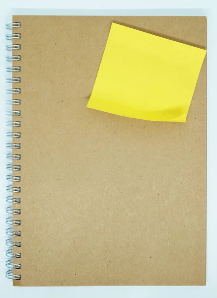 Yellow sticky note on notebook — Stock Photo, Image