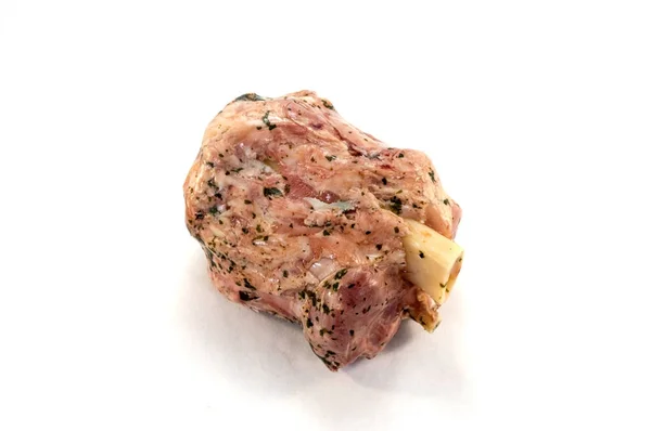 Pork ham with its bone and green parsley on a white background — Stock Photo, Image