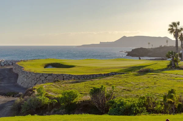 Green golf with flag and hole facing Atlantico ocean in Santa Cr