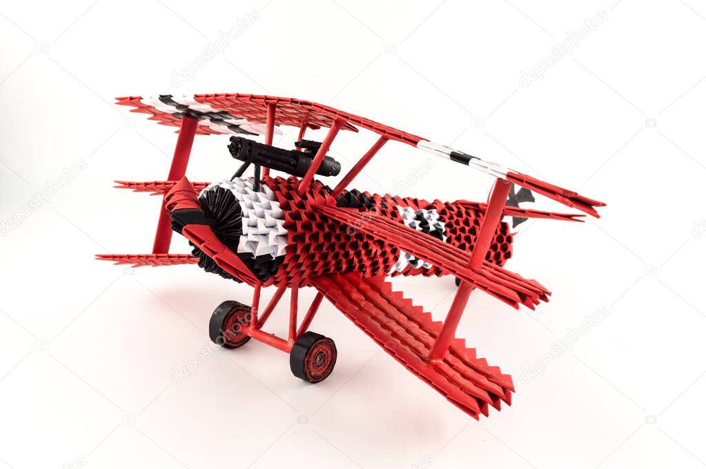 Origami red baron plane on a white background