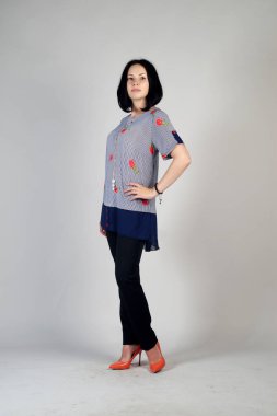 Gri bir arka plan üzerinde poz güzel genç kız