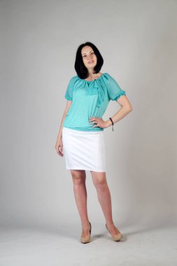 Gri bir arka plan üzerinde poz güzel genç kız