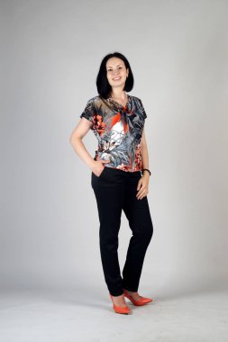 Gri bir arka plan üzerinde poz güzel genç kız