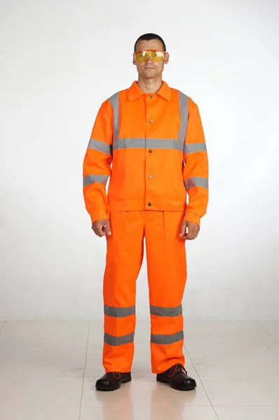 A man in overalls and work wear — Stock Photo, Image