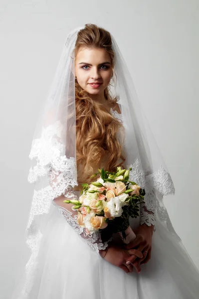 Beautiful young bride and groom posing at studio — Stock Photo, Image