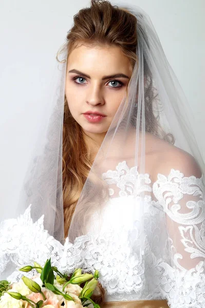Schöne junge Braut und Bräutigam posiert im Studio — Stockfoto