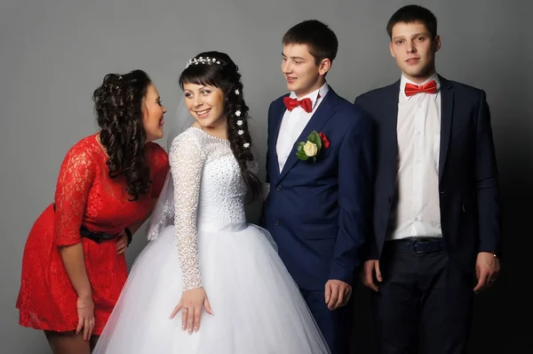 Beautiful bride with her girlfriends posing at studio — Stock Photo, Image