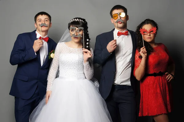 Beautiful bride with her girlfriends posing at studio — Stock Photo, Image