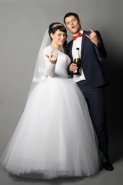 Beautiful young bride and groom posing at studio — Stock Photo, Image