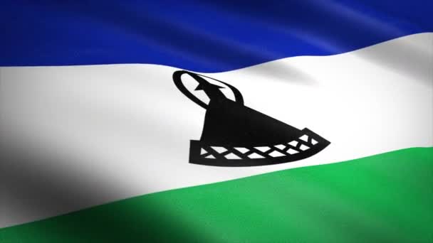 Lesotho zászlója. Lengő zászló nagyon részletes szövet textúra zökkenőmentes hurkolható videó. Zökkenőmentes hurok rendkívül részletes szövet textúra. A hurok 4k felbontásban kész — Stock videók