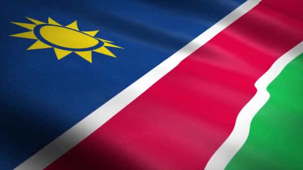 Namíbia zászlója. Lengő zászló nagyon részletes szövet textúra zökkenőmentes hurkolható videó. Zökkenőmentes hurok rendkívül részletes szövet textúra. Hd felbontásban kész hurok — Stock videók