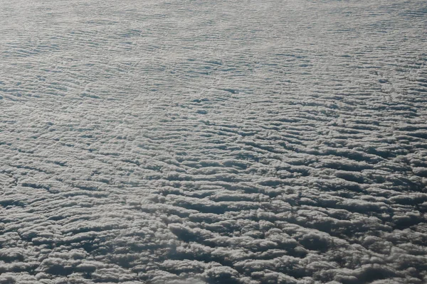 Sky cloudy overcast. Clouds texture background. View on blue clouds from above. View from airplane. Layer of clouds top view — Stock Photo, Image