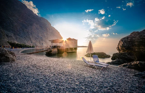 Glyka Nera beach (Sweet Water or Fresh Water). View of the remote and famous Sweet Water Beach in south Crete, with its unique tavern on the rock inside sea. This is a nudist beach.