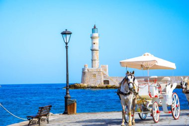 Panorama of the old harbor of Chania with horse carriages and mosque, Crete, Greece. clipart