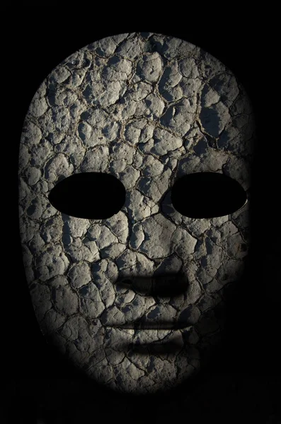 Textured mask with cracked rough wood  painted surface, neutral expression on dark background. — Stock Photo, Image