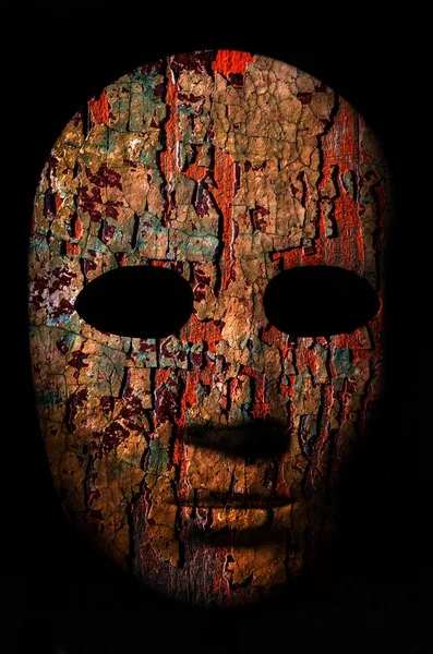 Textured mask with cracked rough wood  painted surface, neutral expression on dark background. — Stock Photo, Image