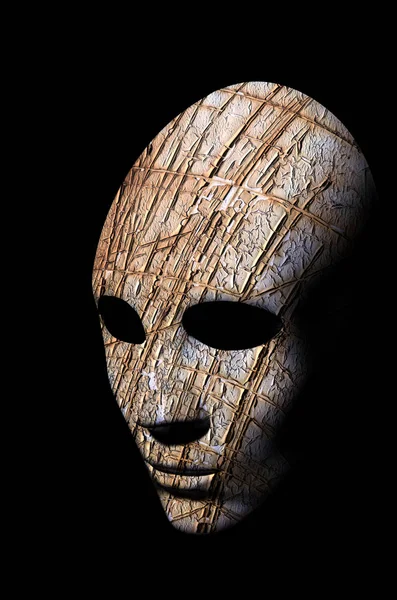 Textured mask with cracked rough wood  painted surface, neutral expression on dark background. — Stock Photo, Image