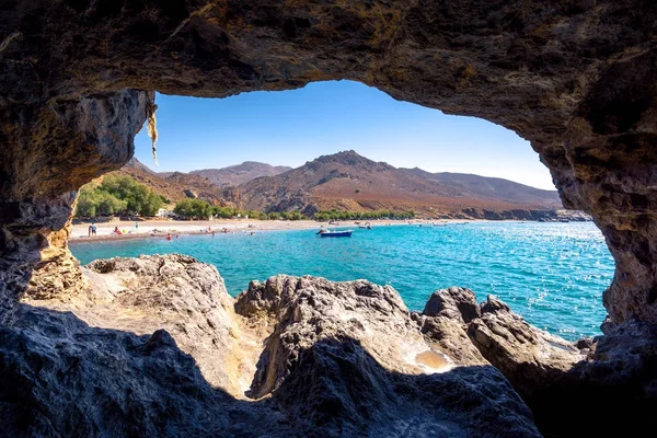 The amazing tropical beach of Panagia Tripiti through a cave, in Crete, with sandy beach, turquoise water and some lucky campers, Greece. — 图库照片
