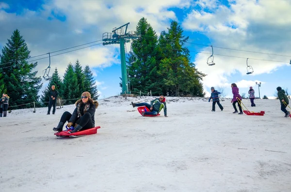 Family have fun with ski vehicles at Pertouli ski center, trikala, Greece on December 27, 2016. — Stock Photo, Image