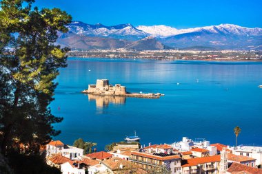 The Bourtzi water castle is a small island with a fortress at the coast of Nafplio in Greece clipart