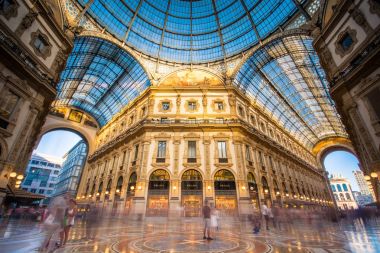 MILAN, ITALY - July 2, 2017: Galleria Vittorio Emanuele II in Milano. It's one of the world's oldest shopping malls, designed and built by Giuseppe Mengoni between 1865 and 1877. clipart