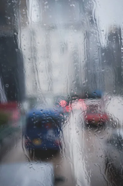 Blurred rain drop on the Bus glass,Urban view of rain drops fall