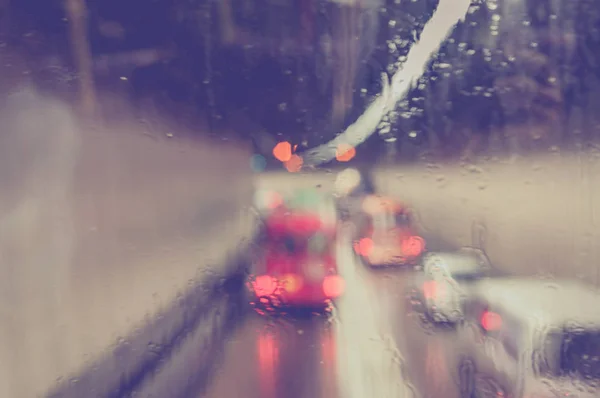 Blurred rain drop on the Bus glass,Urban view of rain drops fall