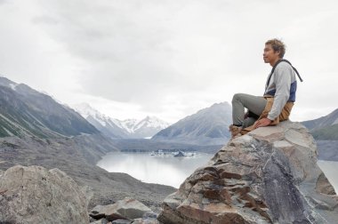 Yeni Zelanda'nın en uzun buzulun başladığı Tasman Buzulu bakış açısı ve buz terminal göle Aoraki buluştuğu alt ulaşır bir adama / Mount Cook Milli Parkı