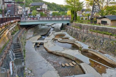 Kobe, Japan - March 2016: Hot spring stream flowing pass town centre of Arima Onsen in Kita-ku, Kobe, Japan. clipart