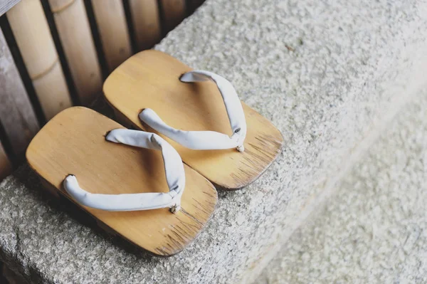 Geta or traditional Japanese footwear, a kind of flip-flops or sandal with an elevated wooden base held onto the foot with a fabric thong strap — Stock Photo, Image