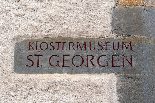 Stein Am Rhein, Switzerland - October 2019: Stone signage of St. George's Abbey Museum installed on the wall of the abbey in Stein am Rhein, Switzerland