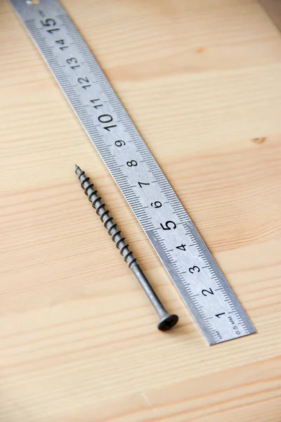 Working process. Screws, ruler.