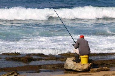İsrail Akdeniz'in kıyısında oturan adam 