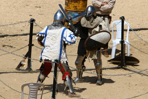 fight of knights on swords in knights' outfit in Israel