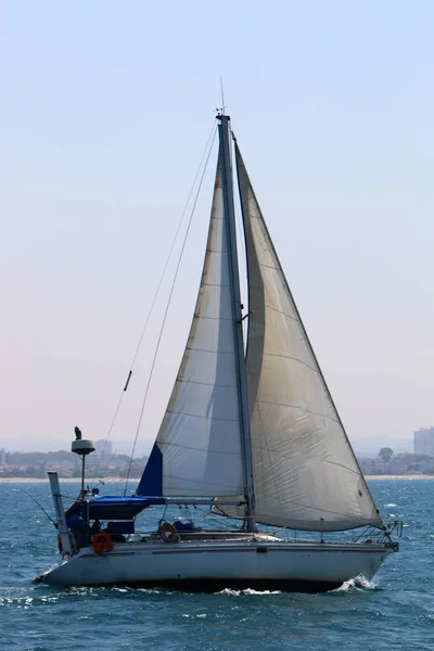 a small yacht in the Mediterranean Sea off the coast of Israel
