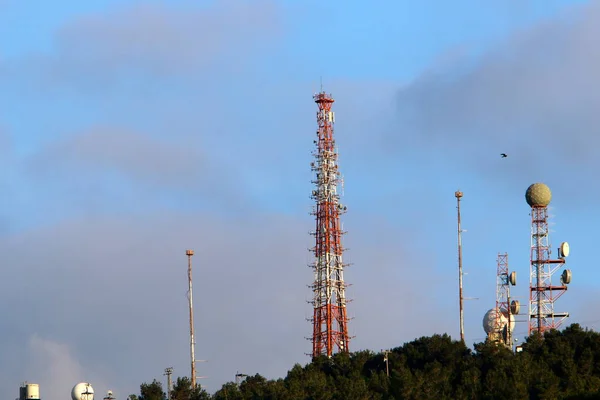 high antenna of radio and television communications against a cloudy sky in northern Israel