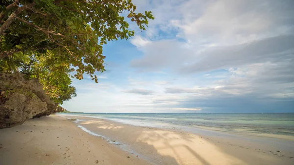 Beautiful gentle nature of the Philippines. The island of Bohol. A beach with sloping cliffs. Anda. Poblacion village.