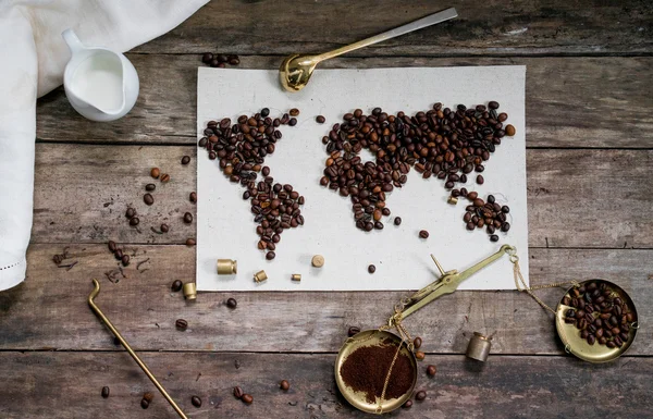 map of the world, coffee beans on old paper. Eurasia, America, Australia, Africa. vintage. Black coffee, ground coffee, scales on wooden background . top view. flat lay